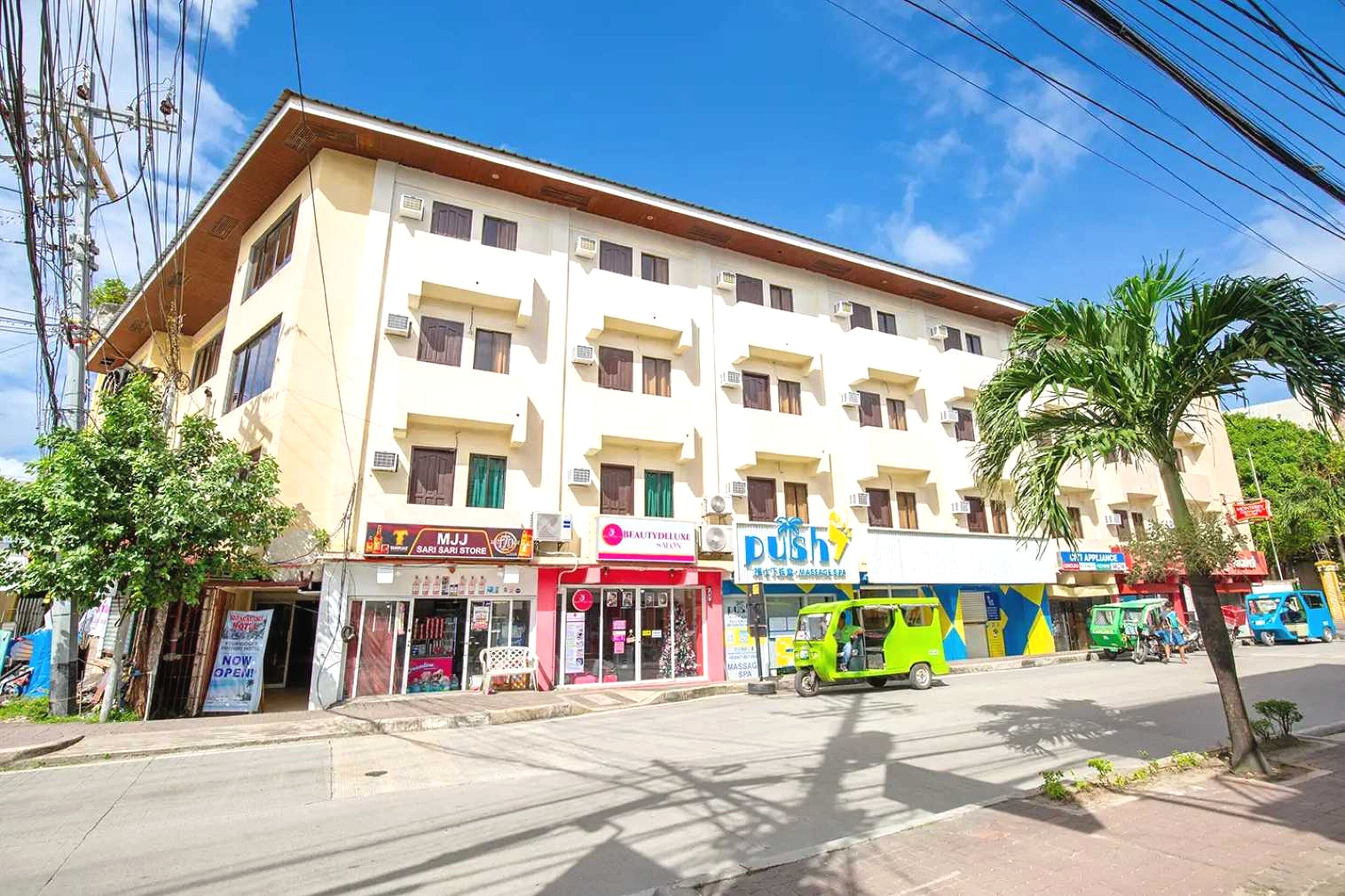 A multi-story building with various storefronts, including a beauty salon and a push-up store.