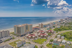 A coastal cityscape with a beachfront, high-rise buildings, and a mix of residential and commercial structures. - 10% off 3-7 thru Sept. 2 BR OF condo in Cherry Grove. Walk-up. Pool. (North Myrtle Beach)