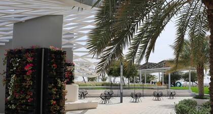 1BR Masdar Getaway | Poolside Living w/ Parking