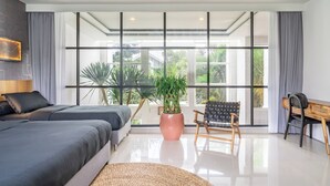 A modern hotel room with a large window, a bed, a desk, and a chair. - Park Homei (Pecatu)
