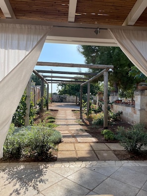 Deluxe Quadruple Room, Garden View | Property grounds