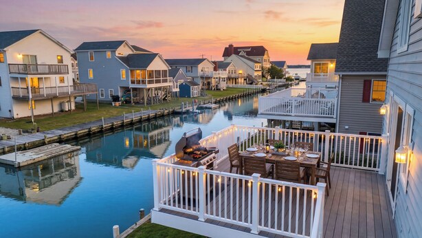 A waterfront property with a dock, a barbecue setup, and a dining area with outdoor seating. - Family Friendly Waterfront Retreat - Dogs Allowed & Off-Season Discounts (Selbyville)