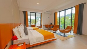 A hotel room with two beds, a dining table, and a balcony with orange chairs. - Sun Top Grand (Ella)