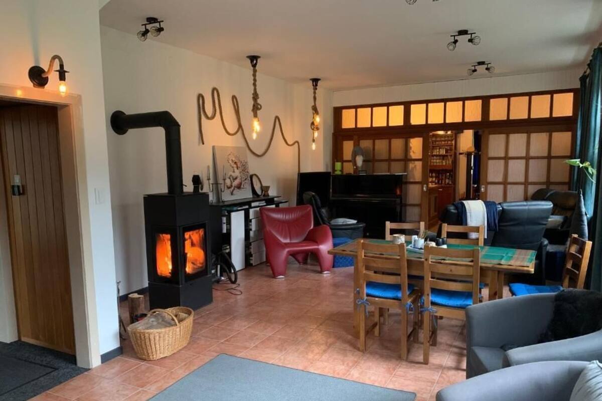 A living room with a fireplace, a dining area, and a sofa.