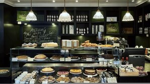 A bakery display with various baked goods and a chalkboard menu. - The Bengal Tiger 2 BR With Patio in Notting Hill (London)