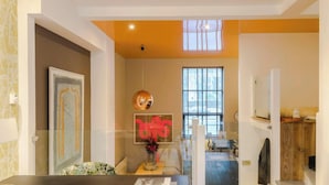 A modern interior with a large window, a ceiling light, and a decorative wall piece. - Neon Melody Playful 2 Bedrooms by London Bridge (London)