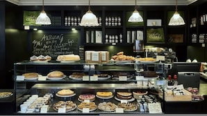 A bakery display with various baked goods and a chalkboard menu. - Whoops-a-daisy 3 Bedroom in Notting Hill (London)