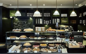A bakery display with various baked goods and a chalkboard menu. - Whoops-a-daisy 3 Bedroom in Notting Hill (London)