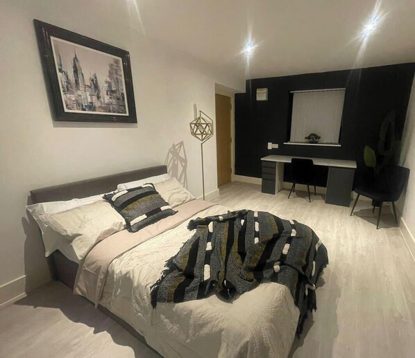 Ein modernes Schlafzimmer mit einem Bett, einem Schreibtisch und einem Stuhl.