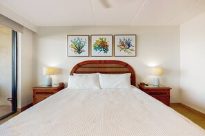 A neatly made bed with a white bedspread, two bedside tables with lamps, and three framed artworks on the wall. - Sweeping View, Luxe Perks: Suntide III - Unit 708 (South Padre Island)