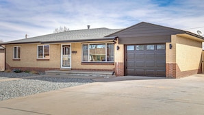 A single-story house with a garage, a front door, and a small front yard with gravel. - Family Friendly! Spacious Lakewood Haven w/ Yard (Lakewood)