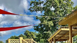 A wooden deck with a pool, a covered barbecue area, and a lattice fence. - Lovely 2-bedroom villa with pool & AC in Combate Beach, Boquerón Puerto Rico. (Cabo Rojo)