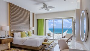 A hotel room with a bed, bedside table, lamp, and a view of the ocean. - Spacious 3-bedroom condo with AC in enchanting Cancún (Cancún)
