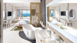 A modern hotel bathroom with a freestanding bathtub, a large mirror, and a view of the ocean. - Spacious 3-bedroom condo with AC in enchanting Cancún (Cancún)