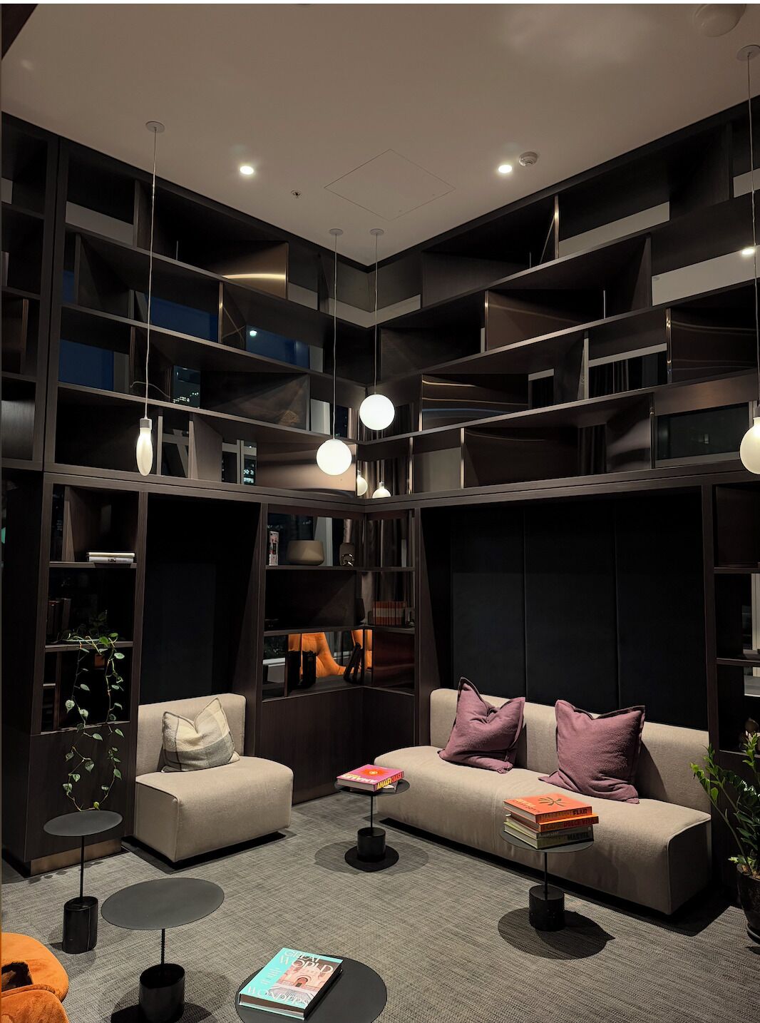A modern living room with a sofa, coffee table, and books.