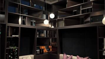 A modern living room with a sofa, coffee table, and books.
