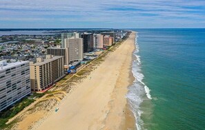 A coastal cityscape with a long sandy beach, high-rise buildings, and a clear view of the ocean. - Oceanfront 3 bedroom corner condo with panormaic ocean, indoor pool and bay views! MB701 (Ocean City)