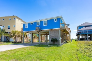 A two-story building with a covered patio area, a pool, and a view of the ocean. - Crystal Blue - 2nd Row - Easy Beach access, fenced yard, steps to the beach! (Crystal Beach)