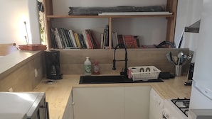 A compact kitchen with a sink, stove, and a small countertop. - Cottage 200 m from Lac des Settons (Montsauche-les-Settons)