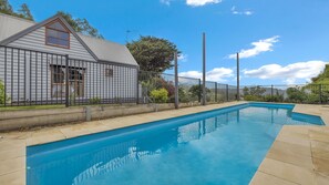A swimming pool with a house in the background. - Leumeah Peaceful rural views (Allambee Reserve)