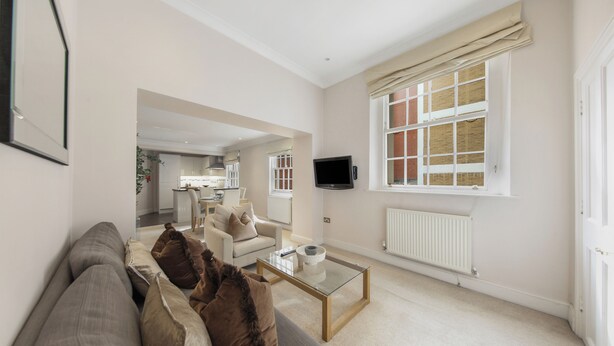 A modern living room with a sofa, coffee table, and a television. - Hertford Flat 5 (London)