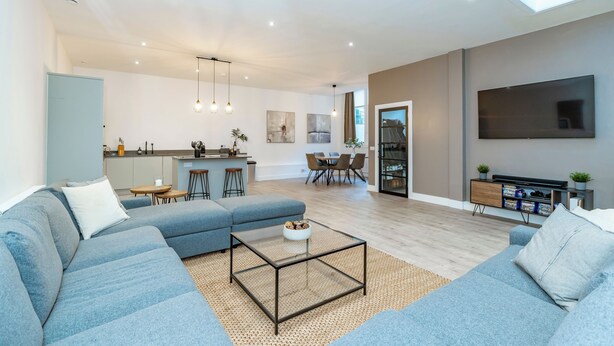 A modern living room with a sofa, coffee table, and a TV. - Morningside Private Residence (Edinburgh)
