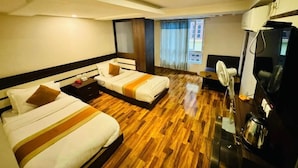 A hotel room with two beds, a coffee machine, a TV, and a window with curtains. - Hotel Dhaka Express (Kathmandu)