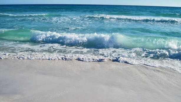 A beach with waves approaching the shore. - Barefoot Bliss | Lakefront Villa Steps from Miramar Beach (Miramar Beach)