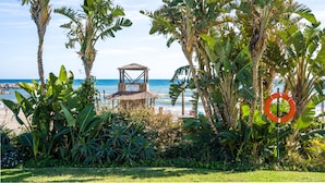 A beach with palm trees, a lifebuoy, and a hut labeled 'AQUA BEACH.'