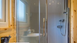 A glass-enclosed shower with a handheld showerhead and a handheld faucet. - Bidean - Cosy Eco Cabin with stunning views (Leacantuim, Glencoe)