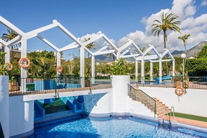A swimming pool with a white structure, stairs, and lifebuoys. - Rental BB 916-3 in Benalm Dena (Benalmádena)