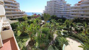 A multi-story hotel with balconies, a landscaped garden, and a beach view. - Rental BB 436-3 in Benalm Dena (Benalmádena)