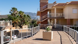 A residential building with a balcony, a carport, and a view of mountains. - AS MM C08 in Mijas Costa (Mijas)