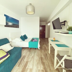 A room with a bed, a desk, a chair, a television, and a picture on the wall. - Tamarindos 1002 in Benalm Dena (Benalmádena)