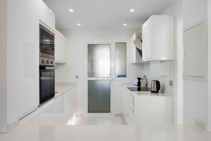 A modern kitchen with white cabinetry, a built-in oven, and a coffee maker. - AS EXT Mijas BC 1 4 15 (Mijas)