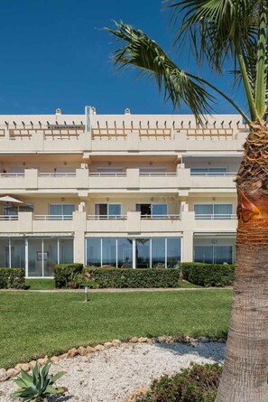 A multi-story hotel with balconies, large windows, and a well-maintained lawn. - AS EXT Mijas BC 1 4 15 (Mijas)