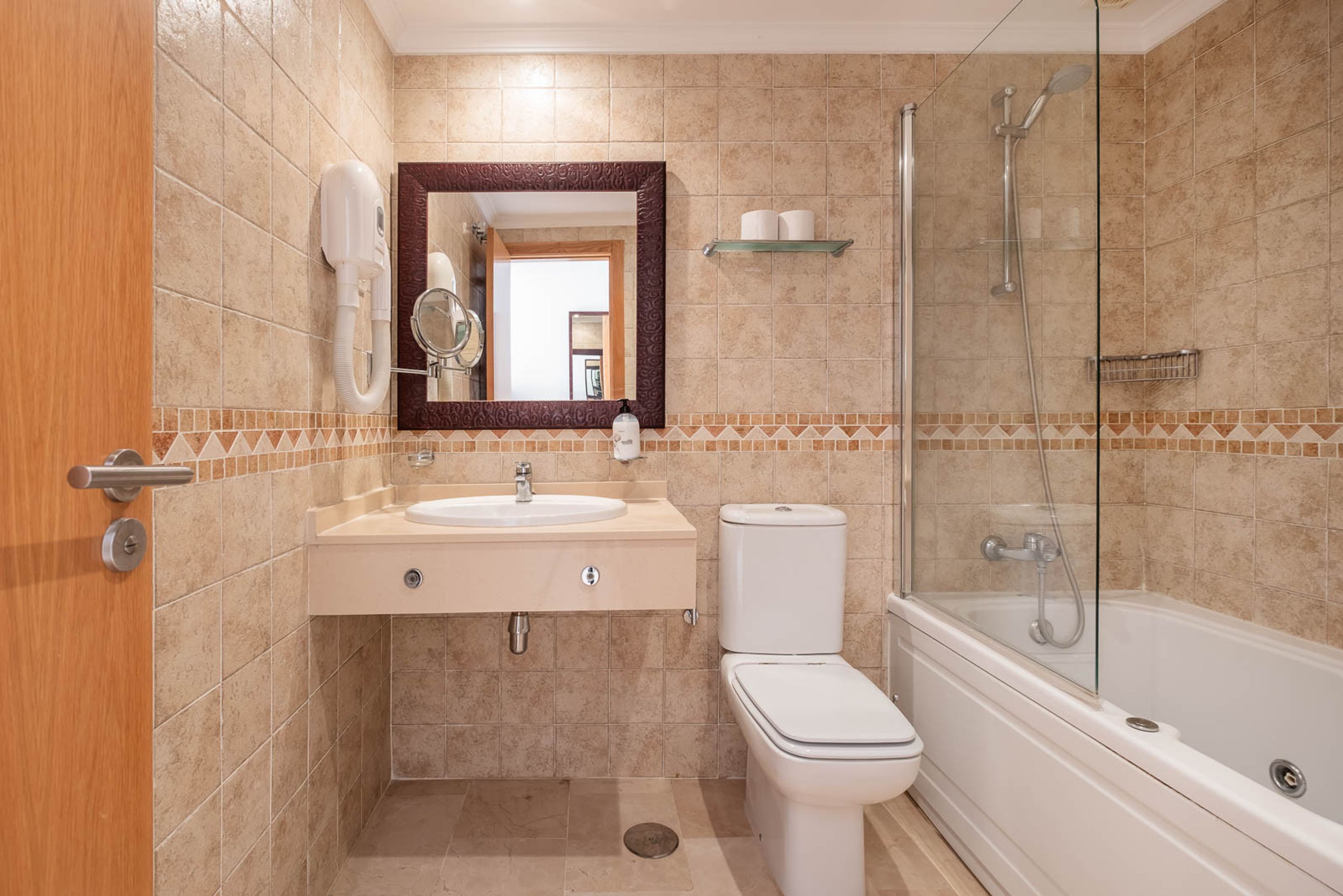 A bathroom with a sink, toilet, and bathtub.