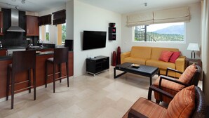 A modern living space with a kitchen, dining area, sofa, and a TV. - AS MM C10 in Mijas Costa (Mijas)