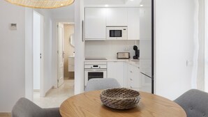 A modern kitchen with white cabinets, a microwave, and a toaster. - AS MDM 5 in Mijas Costa (Mijas)