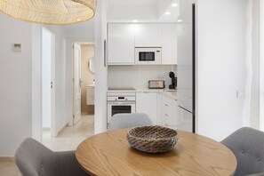A modern kitchen with white cabinets, a microwave, and a toaster. - AS MDM 5 in Mijas Costa (Mijas)