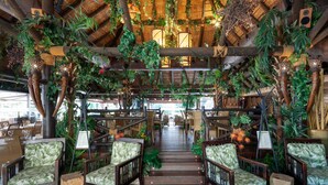 A restaurant with wooden furniture, a staircase, and hanging plants. - AS MDM 5 in Mijas Costa (Mijas)