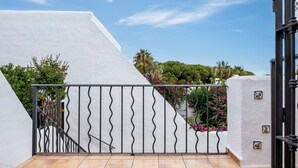 A white building with a metal gate and a staircase leading to a balcony. - AS EXT CBP Samisol FI 2 (Marbella)