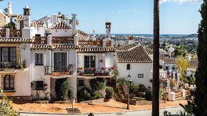 A white building with a tiled roof, balconies, and a view of the city. - AS EXT Mijas Puebla Aida 12L (Mijas)