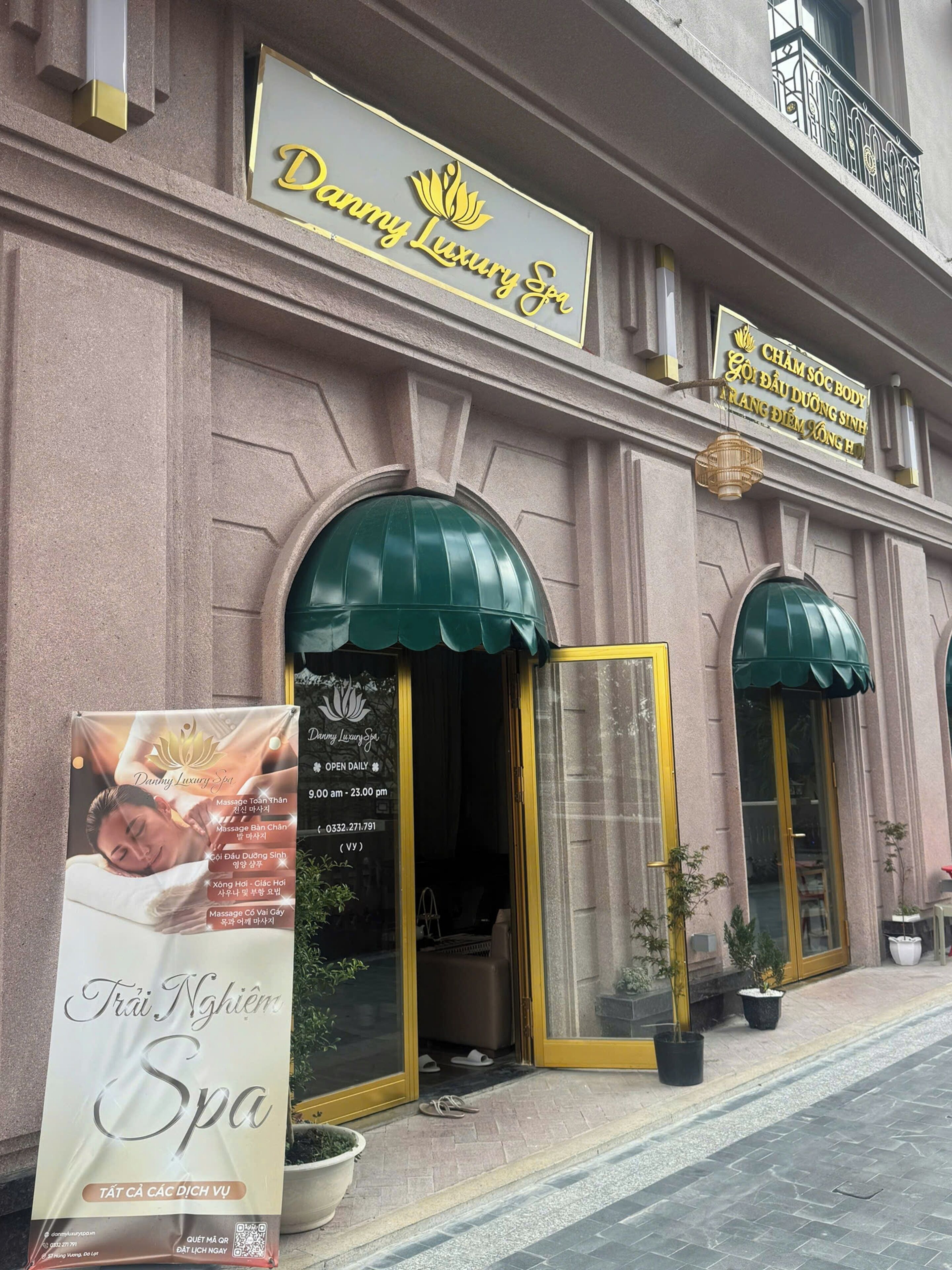 A spa building with a sign reading 'Danny Luxury Spa' and a signboard listing services like massage and body treatments.