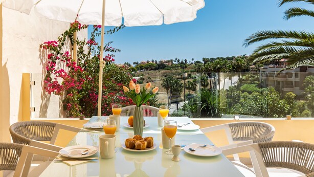 A table set for breakfast with a view of a hillside. - AS SM 175 in Mijas Costa (Mijas)