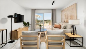 A modern living room with a sofa, two armchairs, a coffee table, a TV, a lamp, and a view of the outdoors. - AS SM 175 in Mijas Costa (Mijas)