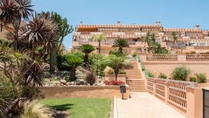 A hotel with a terraced garden, palm trees, and a staircase leading to the entrance. - AS EXT AL 2B1 1 6 in Mijas Costa (Mijas)