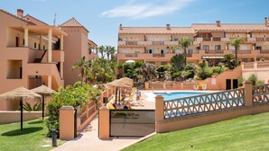 A hotel with multiple balconies, a swimming pool, and lush greenery. - AS EXT AL 2B1 1 6 in Mijas Costa (Mijas)
