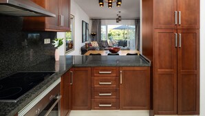 A modern kitchen with granite countertops, wooden cabinets, and a built-in oven. - AS MM C02 in Mijas Costa (Mijas)