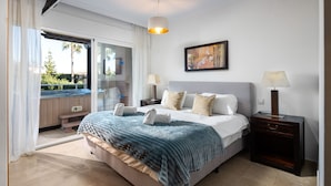 A bedroom with a bed, bedside tables, a nightstand, a window with curtains, and a painting on the wall. - AS MM C02 in Mijas Costa (Mijas)